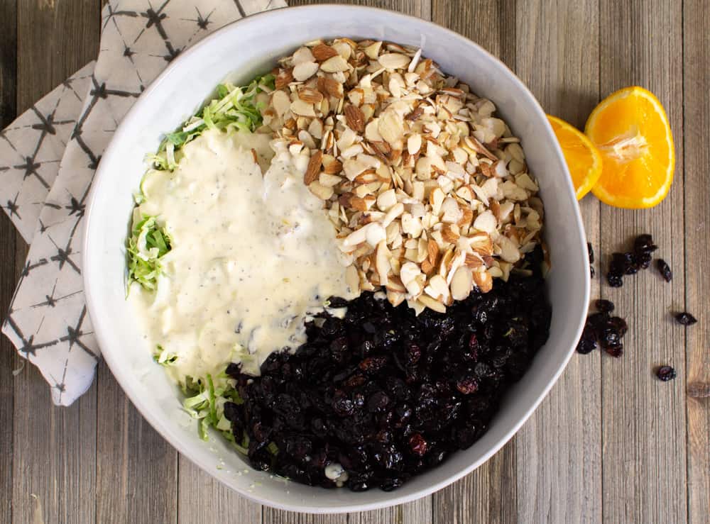 Shaved sprouts with cranberries, almonds, and dressing on top