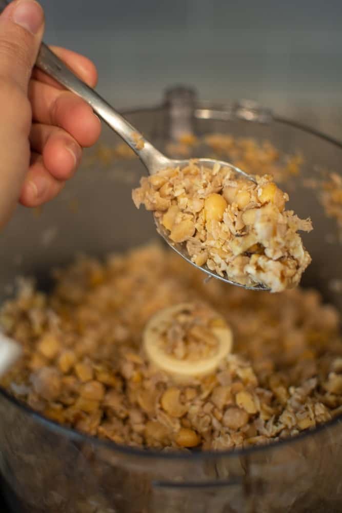 Showing a spoonful of pulsed chickpeas and walnuts
