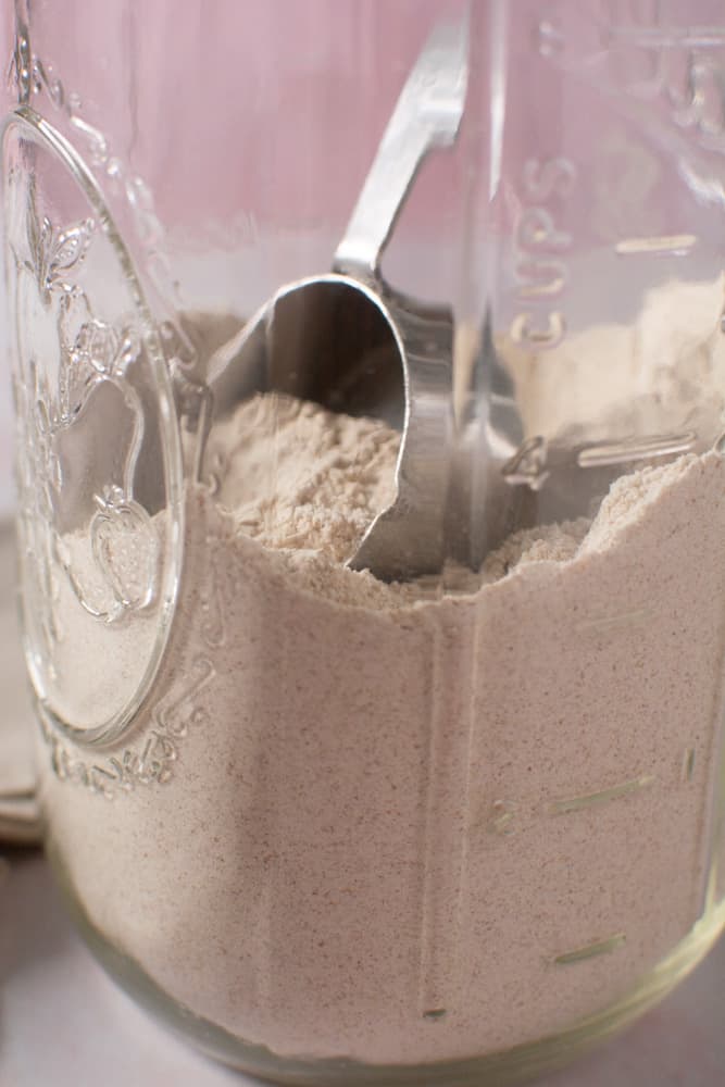 measuring cup in jar full of flour