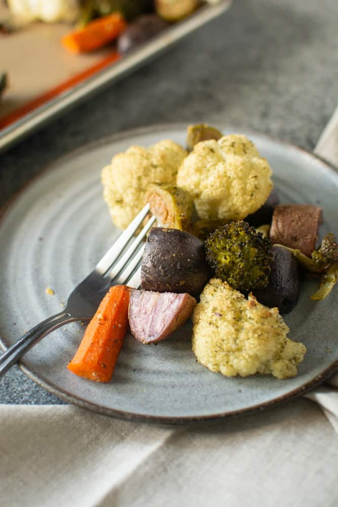 plate full of roasted veggies with fork