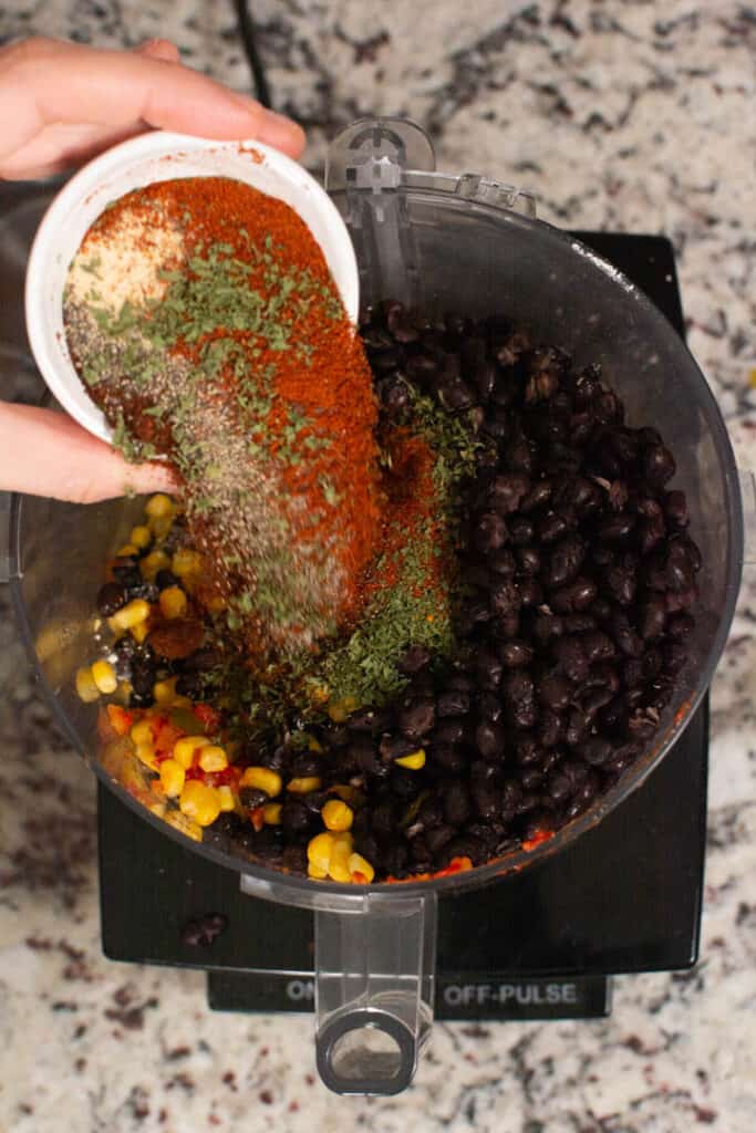 adding spices to food processor