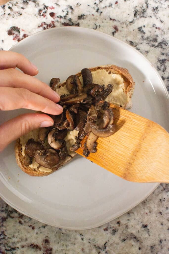 Adding mushrooms to toast