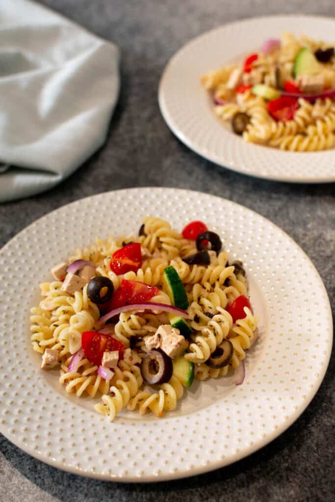 Pasta salad served up on two white plates