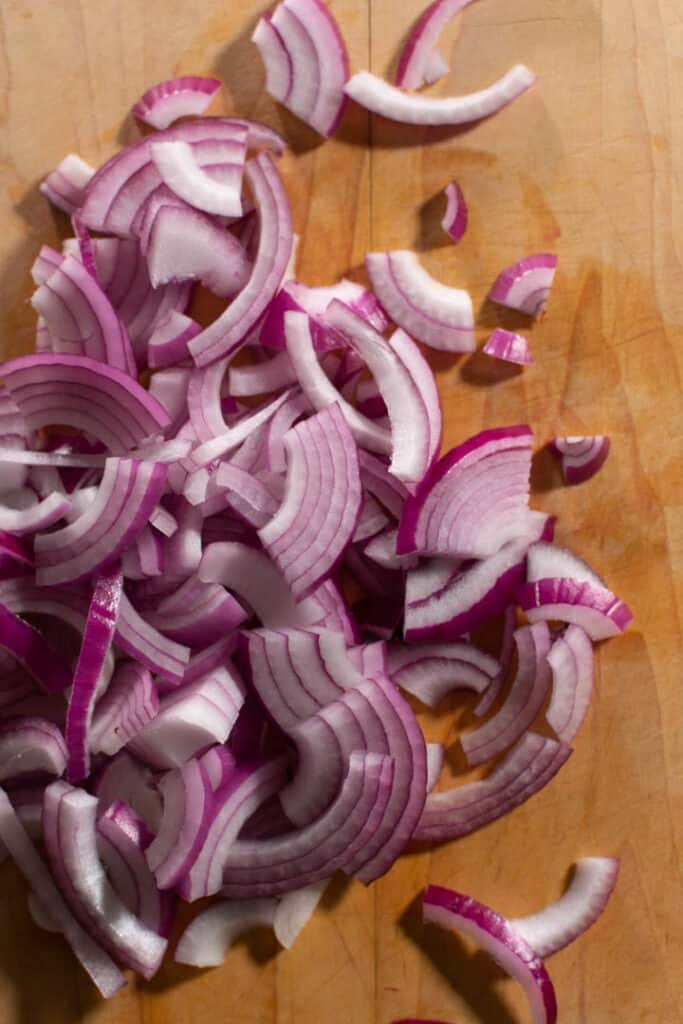 sliced red onion on chopping block