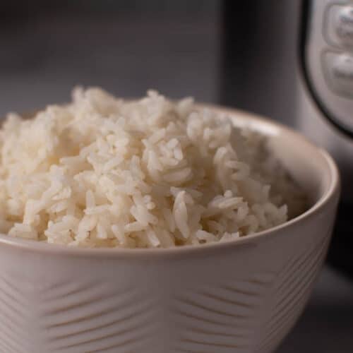bowl of white rice in front on instant pot