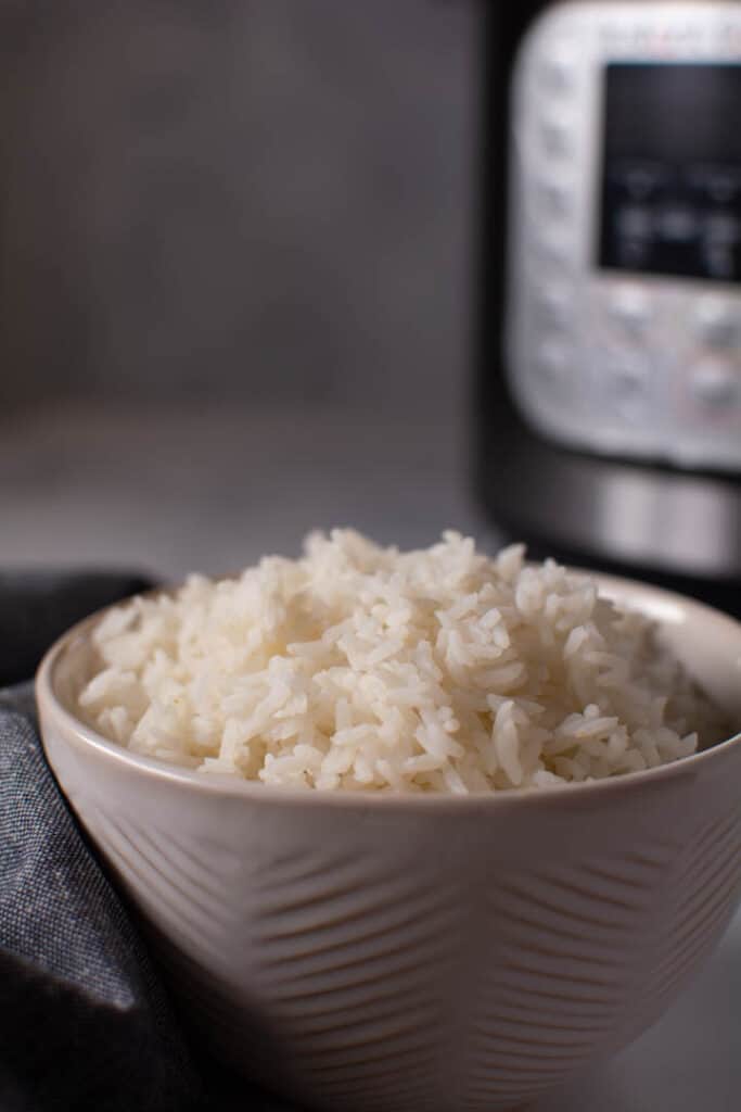 bowl of white rice in front on instant pot