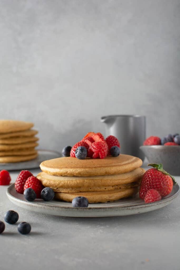 Stack of pancakes with fruit on top