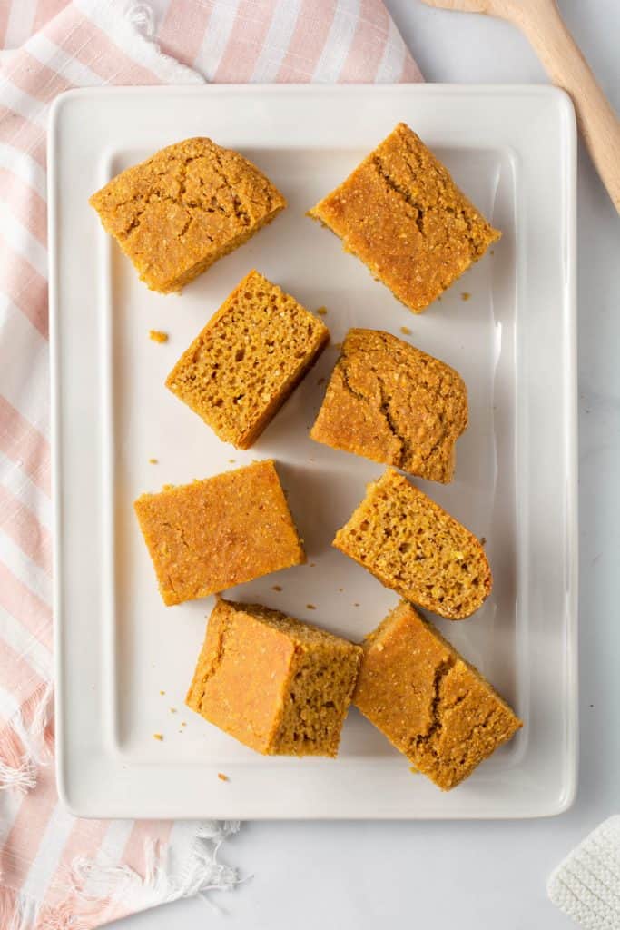 White rectangle platter with slices of cornbread on it.
