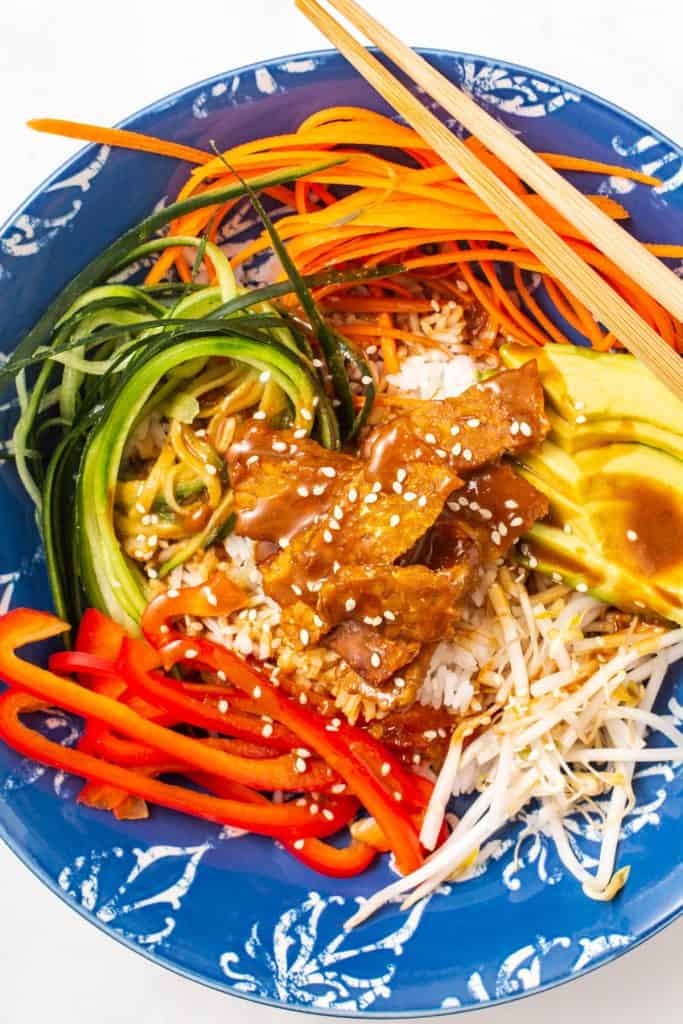 overhead shot of prepared buddha bowl in a blue bowl.