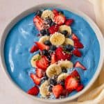 Overhead shot of blue smoothie bowl with toppiongs.