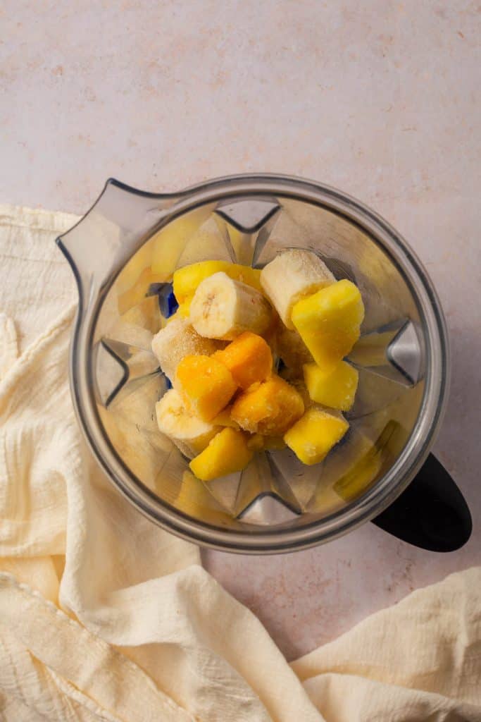 Vitamix full of smoothie bowl ingredients before being mixed together.