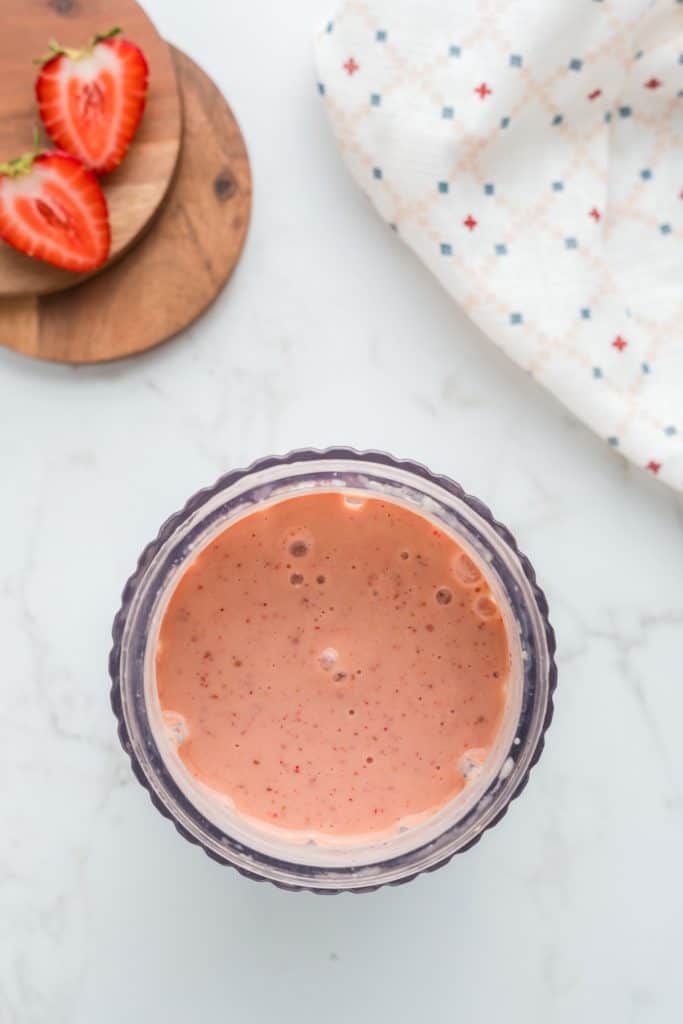 Overhead shot of blended smoothie in blender.