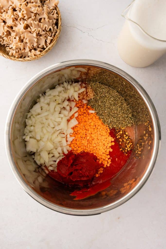 overhead shot of everything in the instant pot except for water, cashew milk, and pasta.