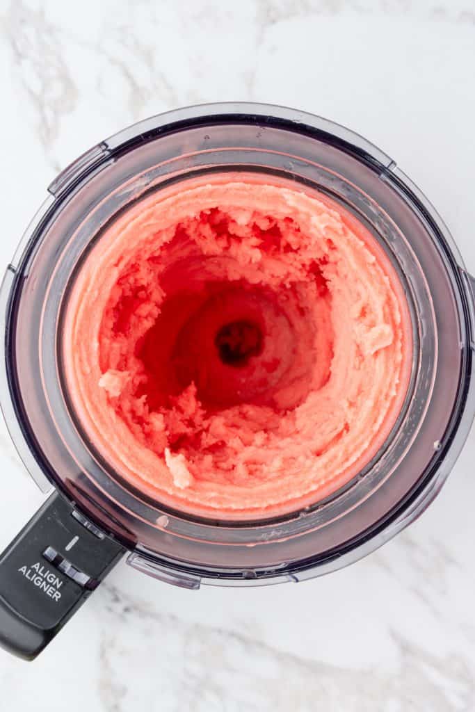 overhead shot of finished watermelon sorbet, in the ninja creami pint container and outer bowl.