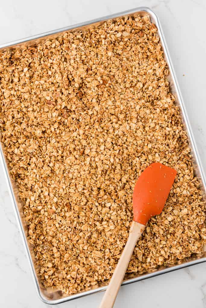 overhead shot of granola pressed into a jelly roll pan before going into the oven.