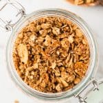 overhead shot of granola in a glass jar.