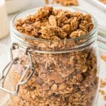 close up of granola in glass jar.