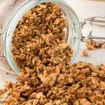 glass container on its side with granola spilling out.