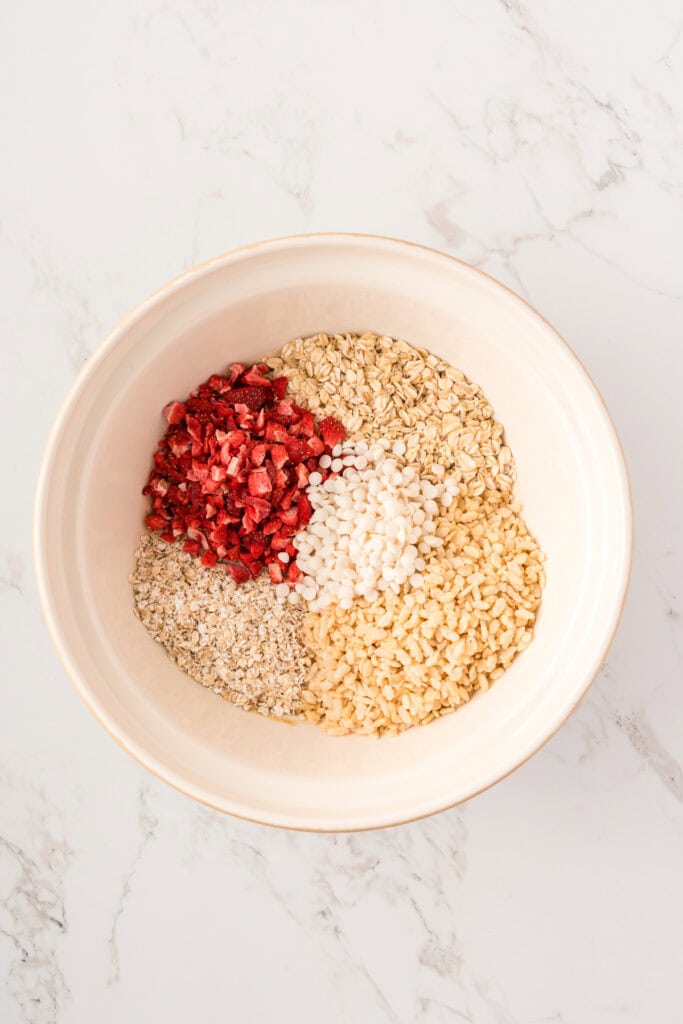 overhead shot of dry ingredients added to wet ingredients in a large bowl.