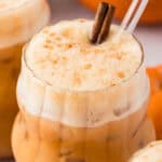 Three glass cups full of iced pumpkin spice chai tea latte.