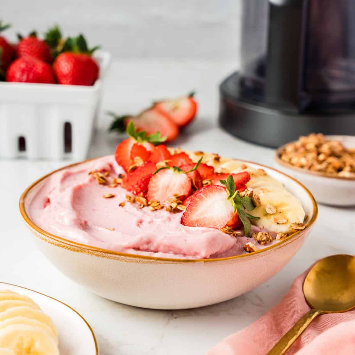 Bowl full of smoothie bowl with fresh fruit on top.